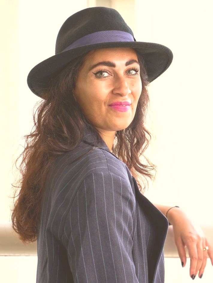 Shazia, portrait in a hat and blazer