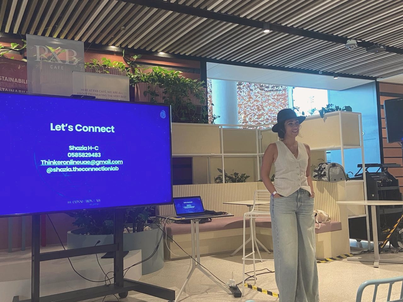 Shazia presenting beside a screen at PXB Terra, Expo City Dubai