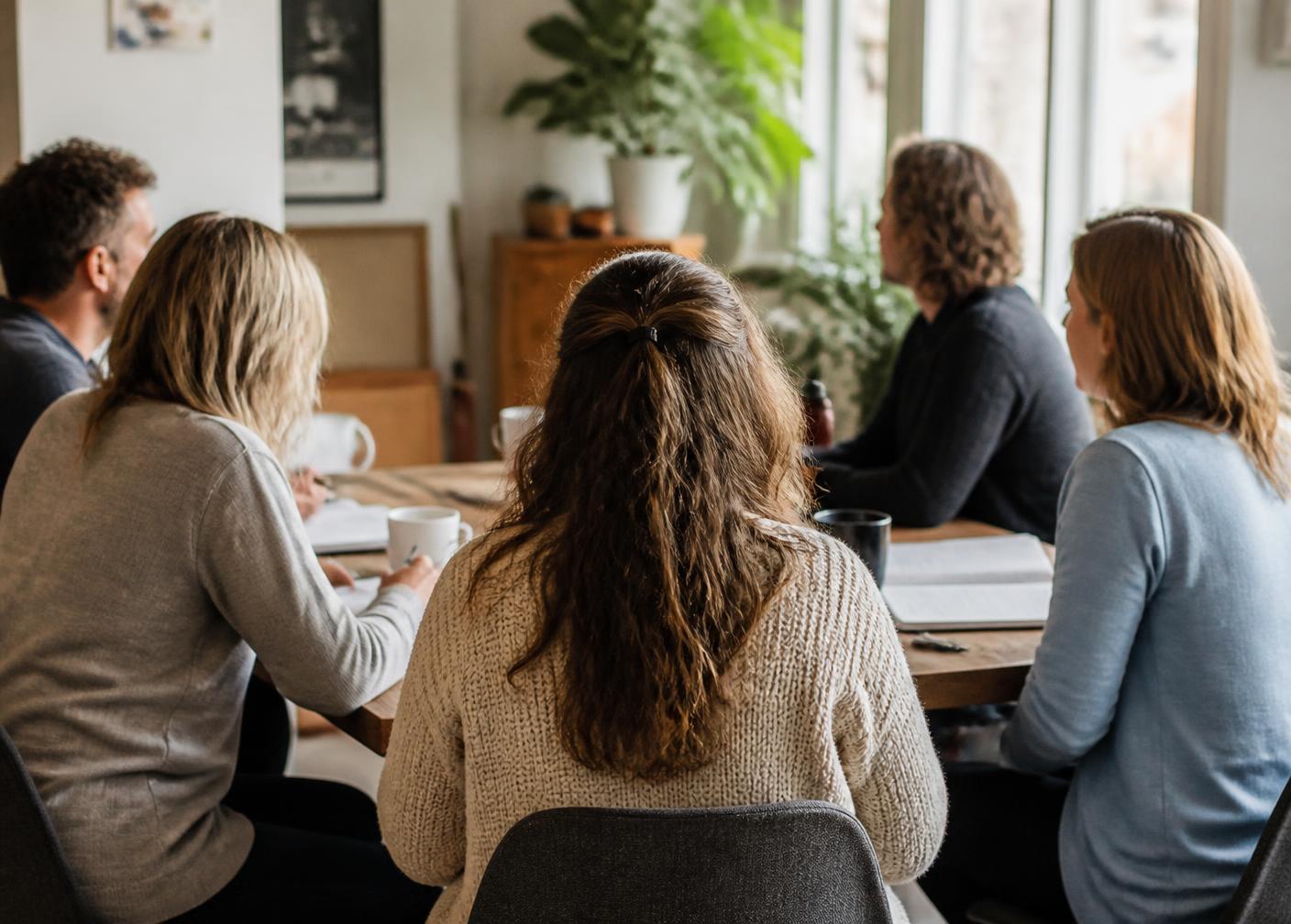 Small group in candid conversation around a table